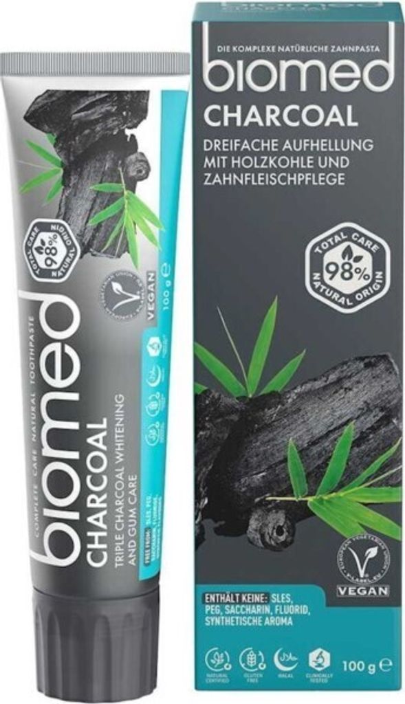 A tube of toothpaste and its box, both featuring charcoal and bamboo imagery.