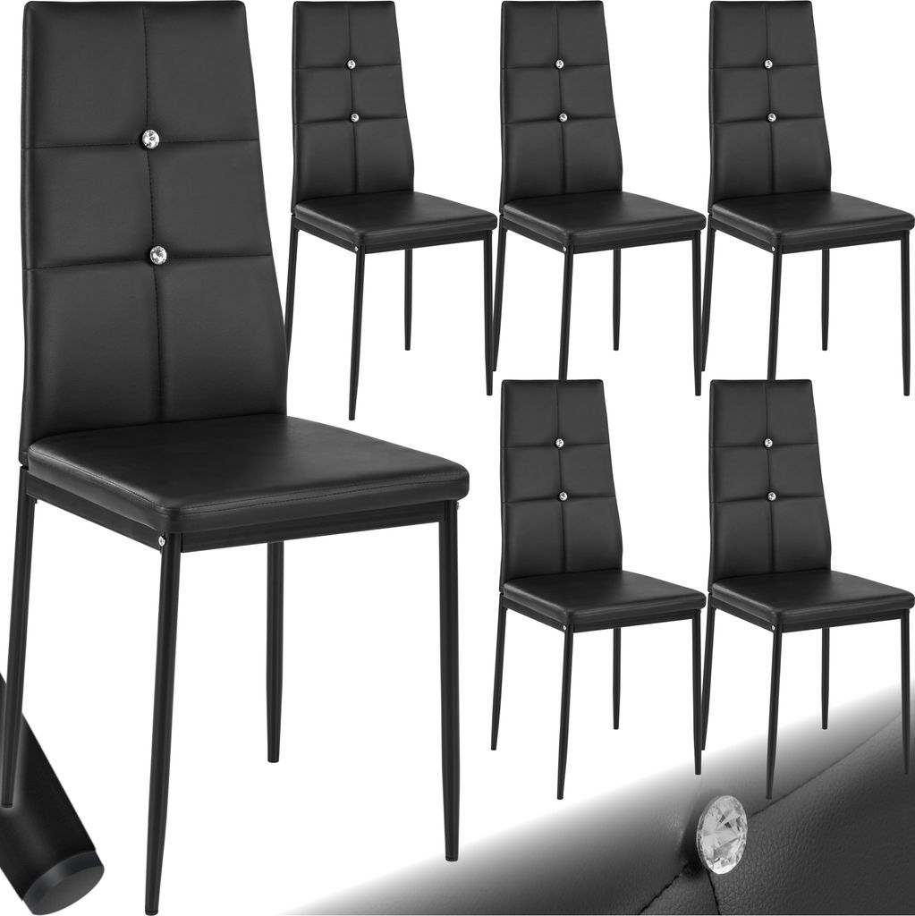 A group of black dining chairs with diamond-like embellishments on the backrests.