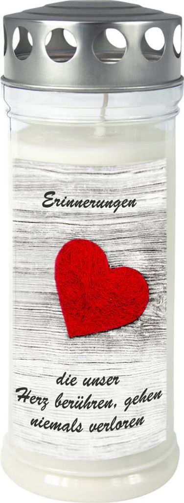 A memorial candle with a heart design and text.