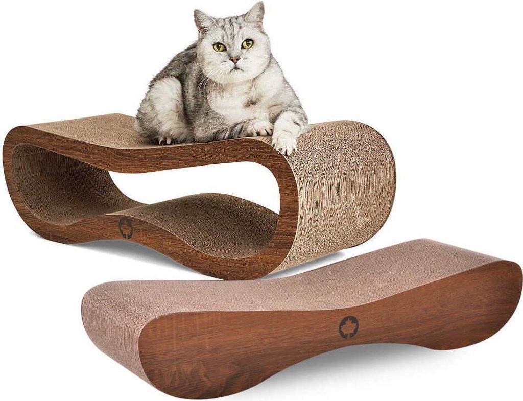 A cat is resting on a cardboard scratching lounge, with another scratching lounge in the foreground.