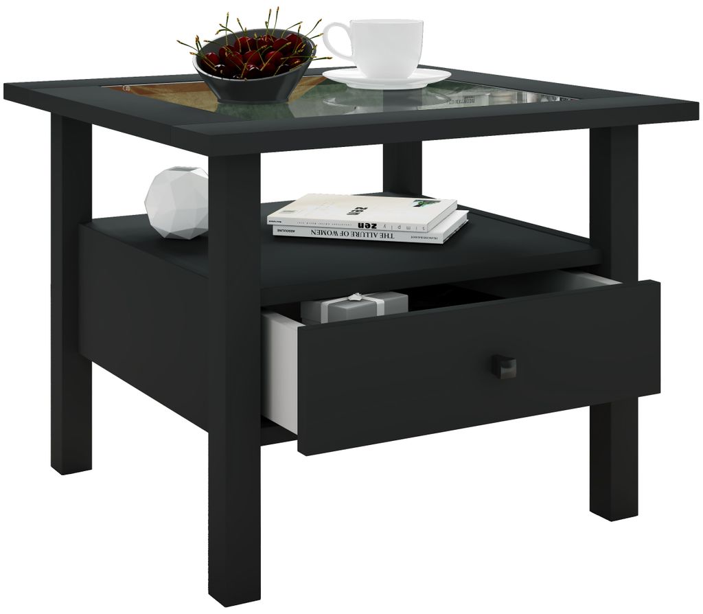 A black side table with a drawer and a shelf, featuring a decorative top and a bowl of red berries, a white cup and saucer, and a white decorative sphere.