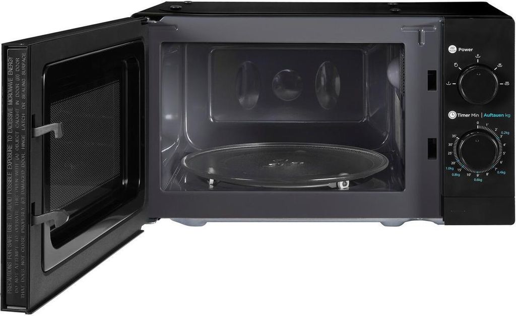An open black microwave oven with a glass turntable inside.