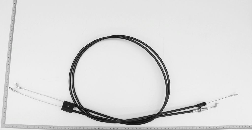 A black cable with silver ends is laid out on a white background, with a ruler alongside it.