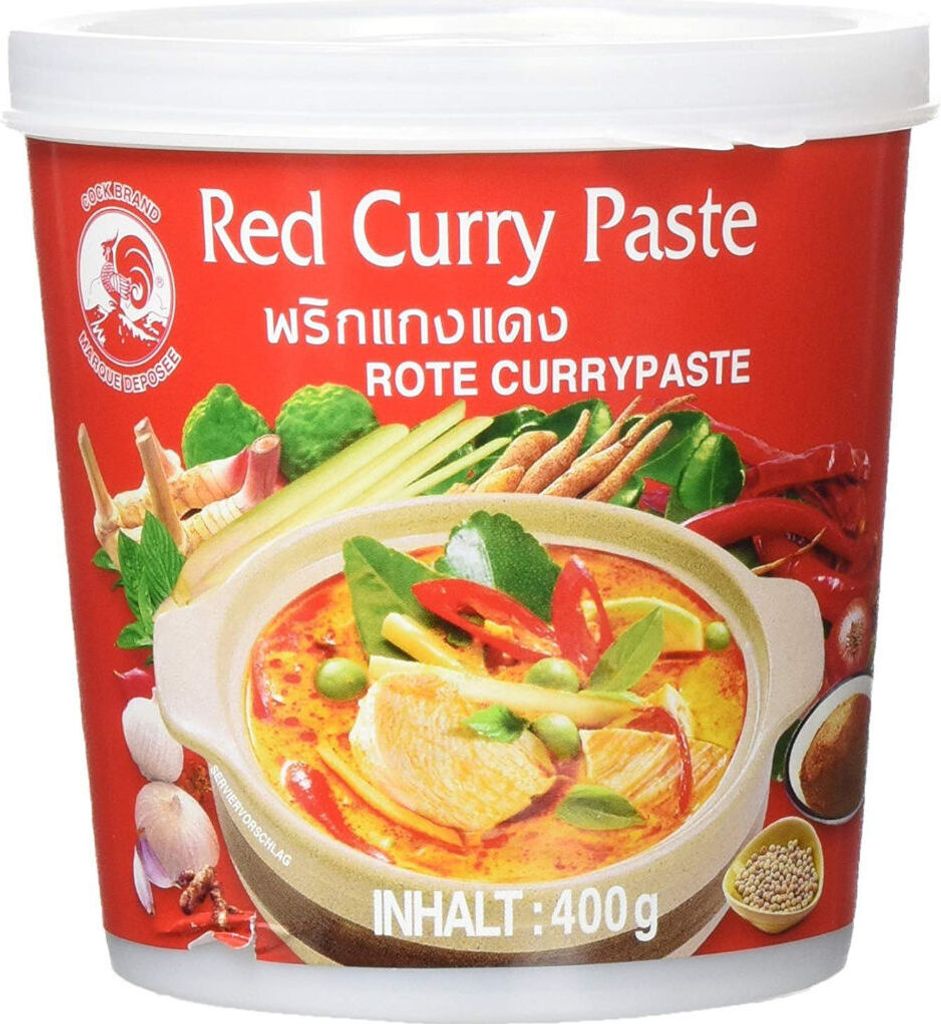 A red tub of Cook Brand Red Curry Paste with an image of curry on the front.