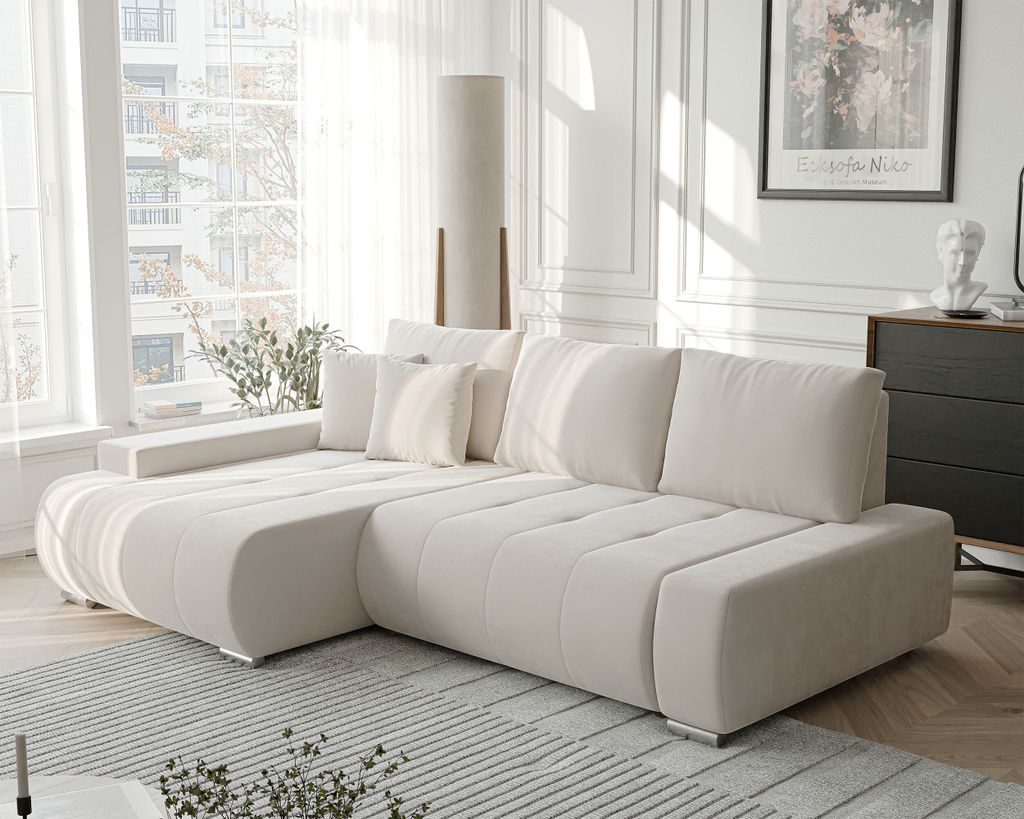 A modern living room with a beige sectional sofa, a floor lamp, and a window with sheer curtains.