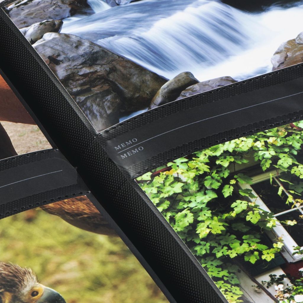 A close-up view of a photo album with multiple photos visible, including a waterfall and greenery.