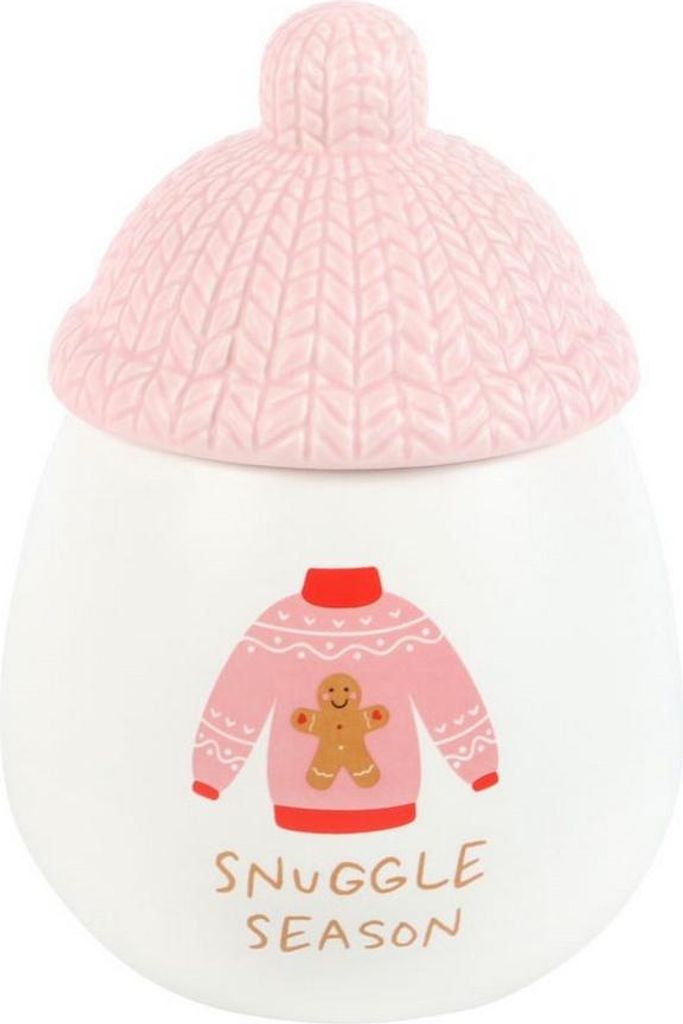 A ceramic jar with a knitted hat lid, decorated with a sweater and gingerbread man graphic, and text.