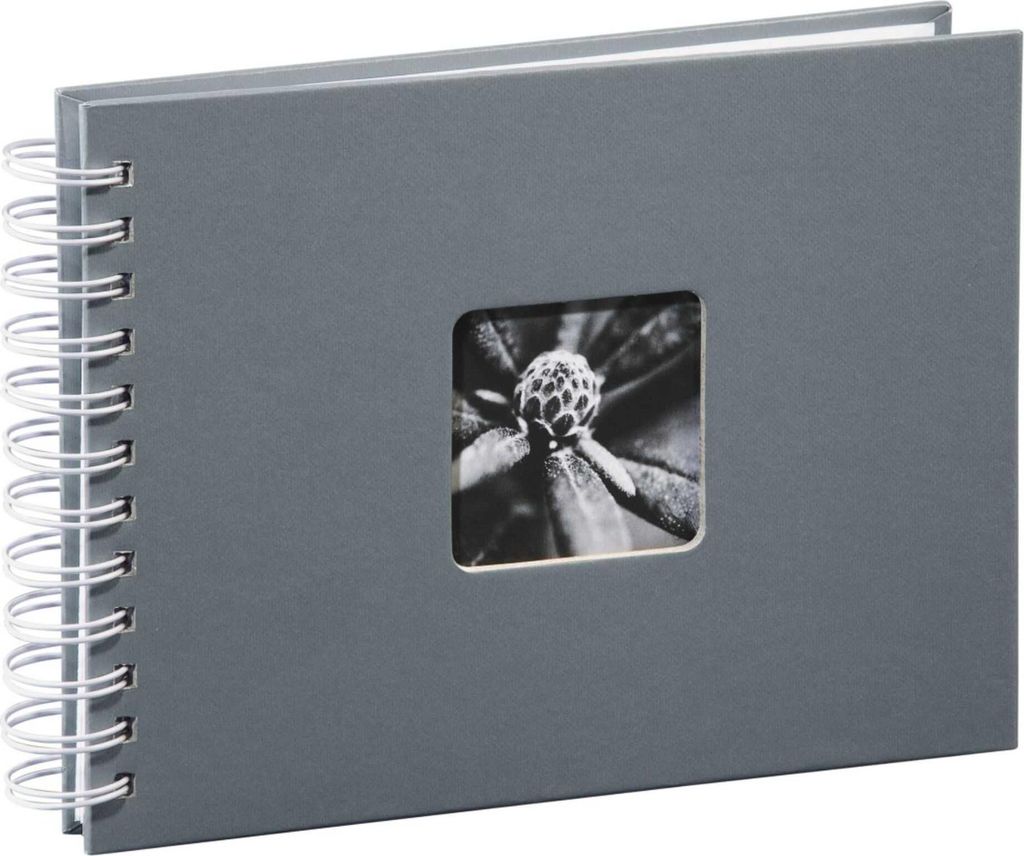 A gray spiral-bound photo album with a square window on the cover showing a black and white close-up of a flower bud.