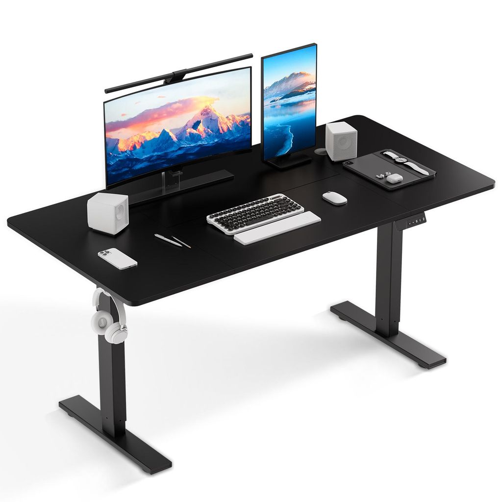 A black adjustable standing desk with two monitors, a keyboard, mouse, and other accessories.