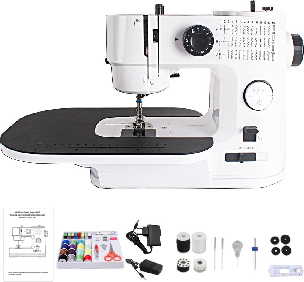 A white electric sewing machine with various accessories laid out below it.