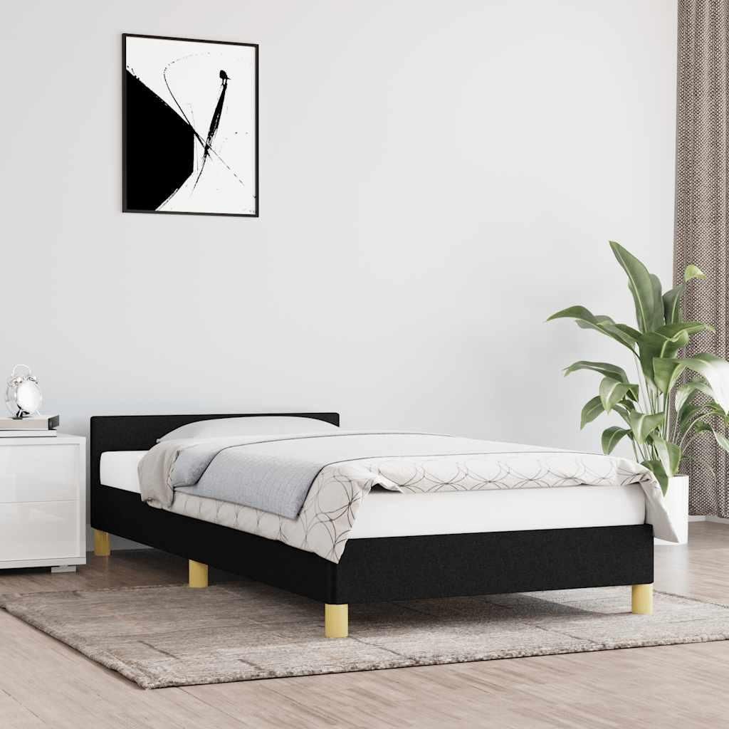 A bedroom scene with a black bed frame and bedding.