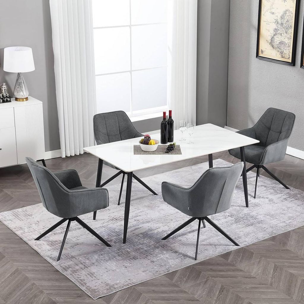 A dining set with a marble-top table and four gray chairs in a well-lit room.