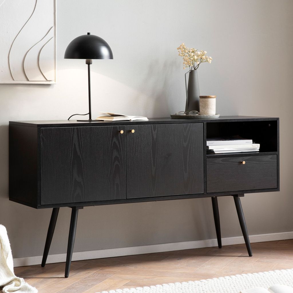 A black sideboard with gold accents in a living room setting.