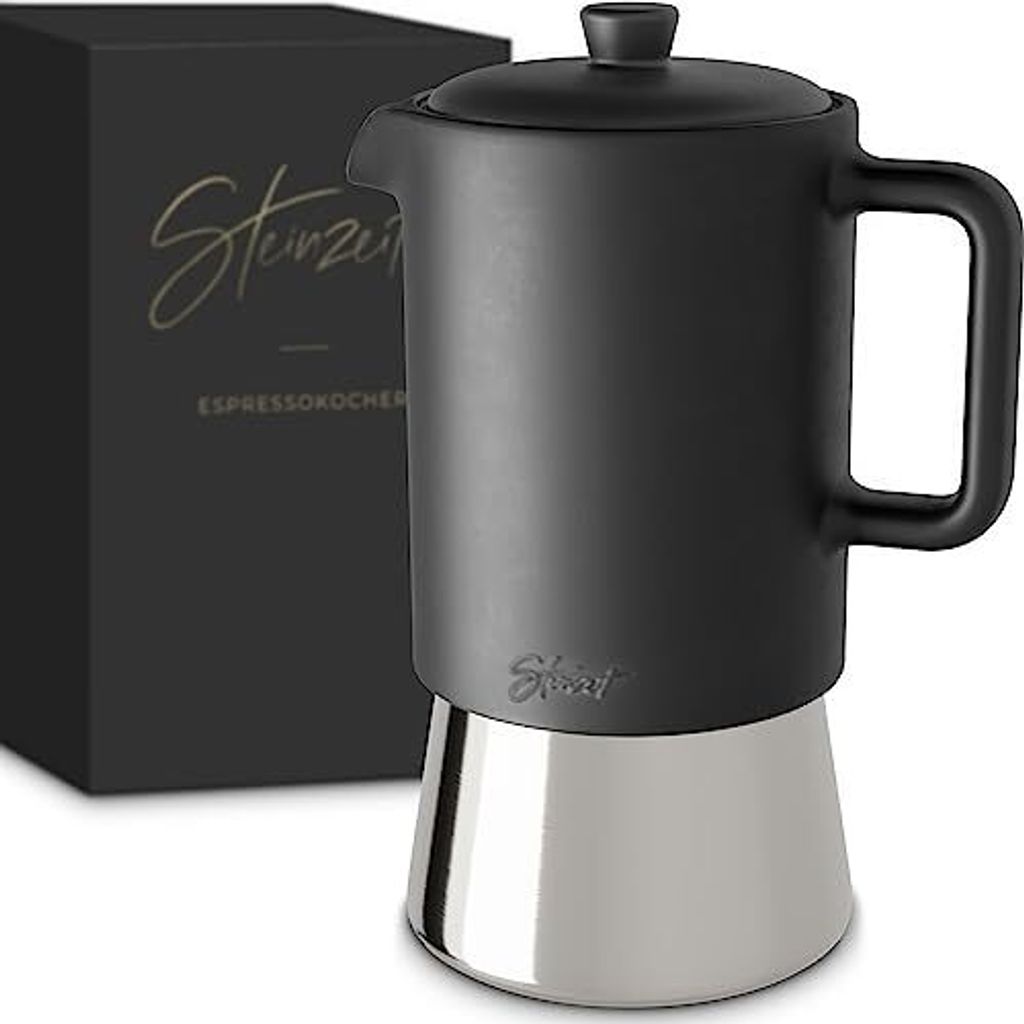 A black and silver stovetop espresso maker next to its packaging.