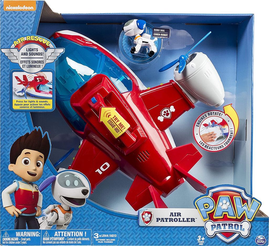 The image shows the packaging of a Paw Patrol Air Patroller toy. The toy airplane is prominently displayed inside the box, along with characters Ryder and a robot dog.