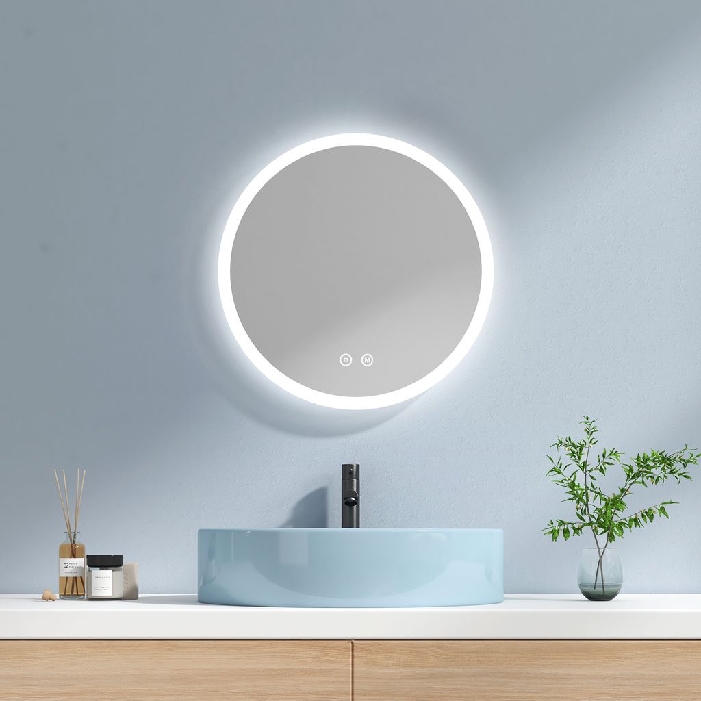 A modern bathroom vanity with a round LED mirror, a blue sink, and a black faucet.