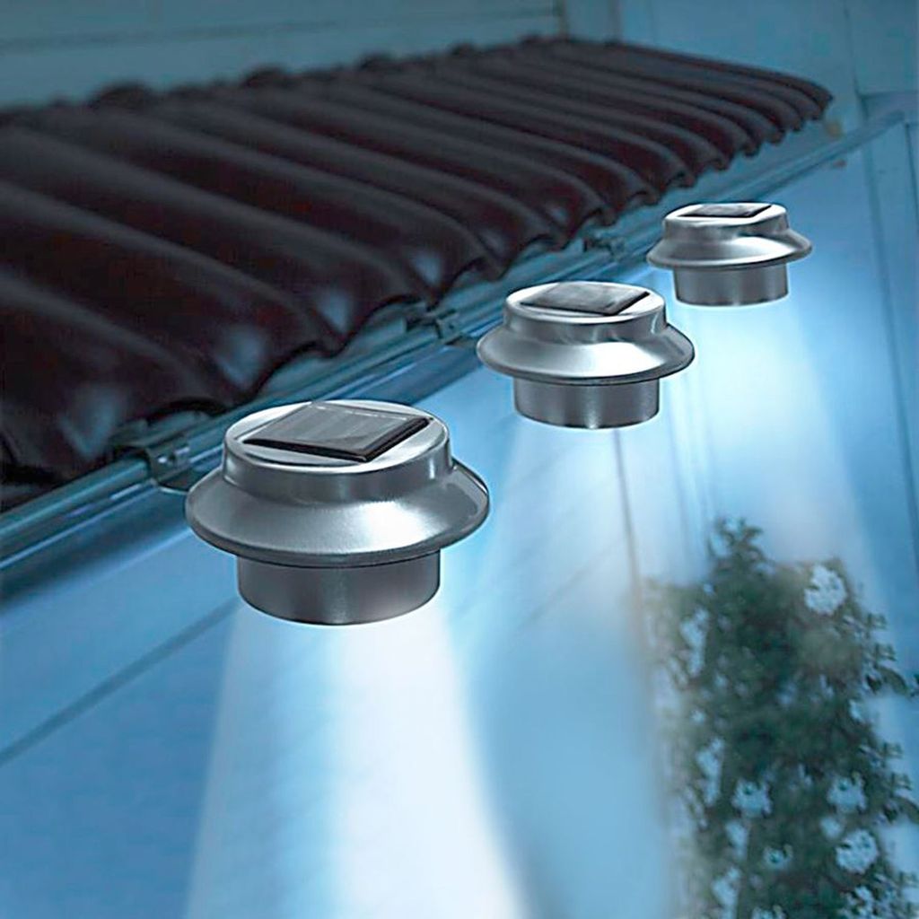 Solar-powered lights attached to a roof gutter, illuminating the area below.
