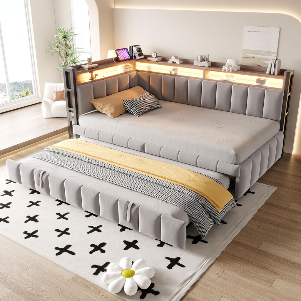 A modern bedroom or living room setting with a sofa bed and a pull-out trundle bed.