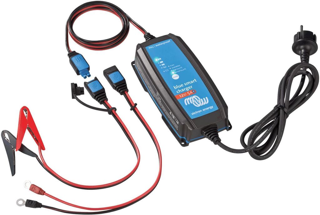 A battery charger with cables and connectors is laid out on a white background.