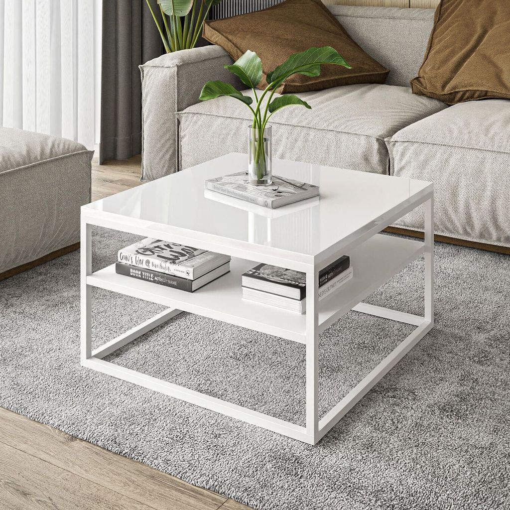 A modern white coffee table with a shelf, placed on a gray rug in a living room setting.