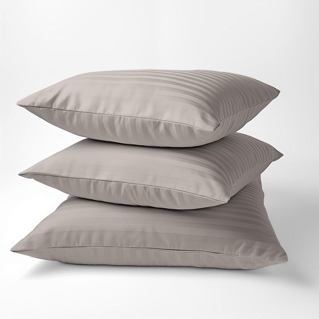 Three beige striped pillows are stacked on top of each other against a white background.