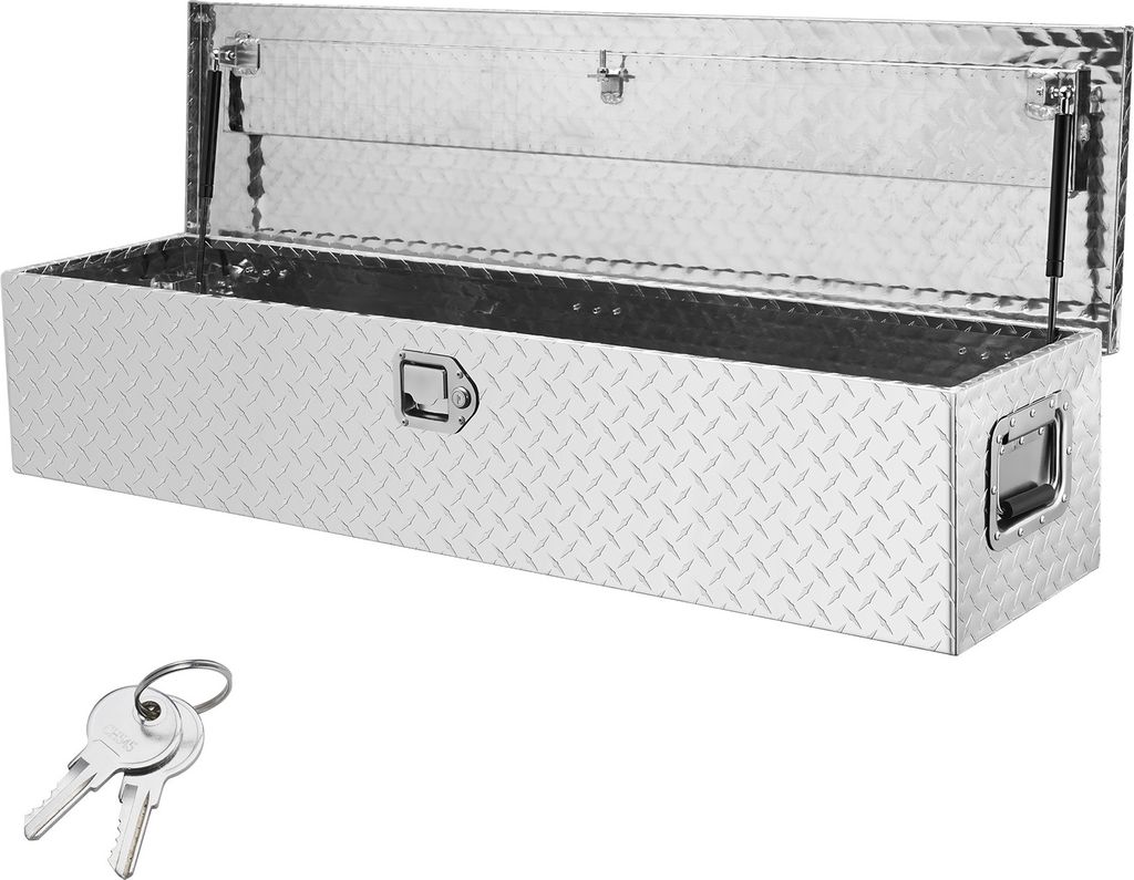 A silver diamond plate truck tool box with the lid open, shown on a white background. Two keys are in the foreground.