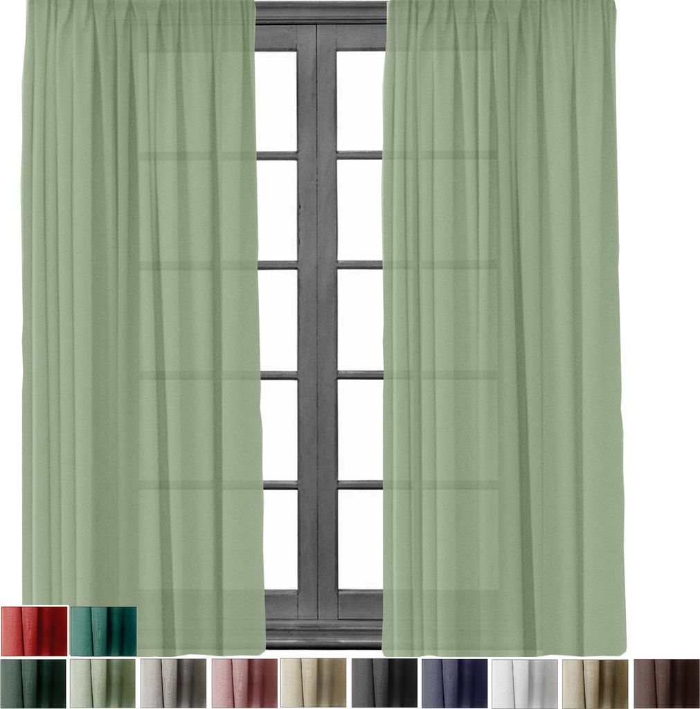 Two light green sheer curtains are shown hanging in front of a dark wooden window frame.