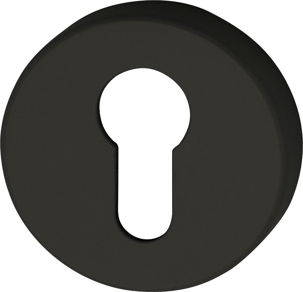 A black circular object with a white keyhole shape in the center.