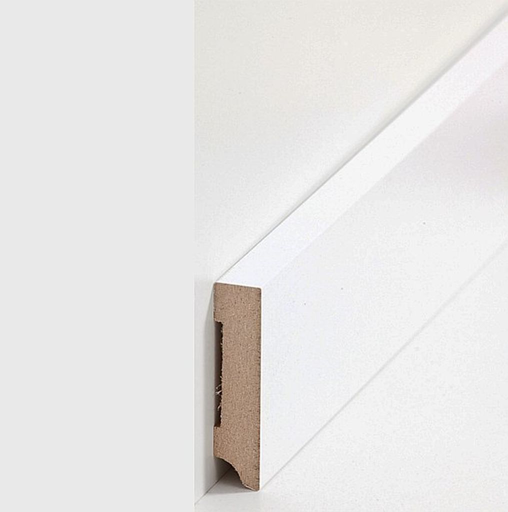 A close-up view of a white MDF baseboard profile against a white wall.