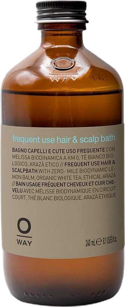 A brown glass bottle of OWAY Frequent Use Hair & Scalp Bath shampoo with a tan label.