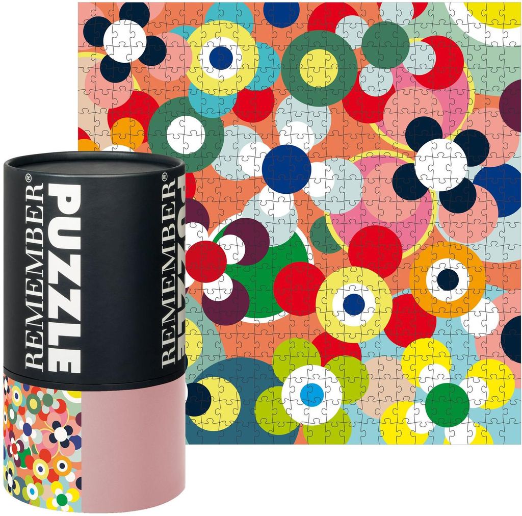 A product shot of a puzzle tube and the puzzle itself, with a colorful, abstract floral design.