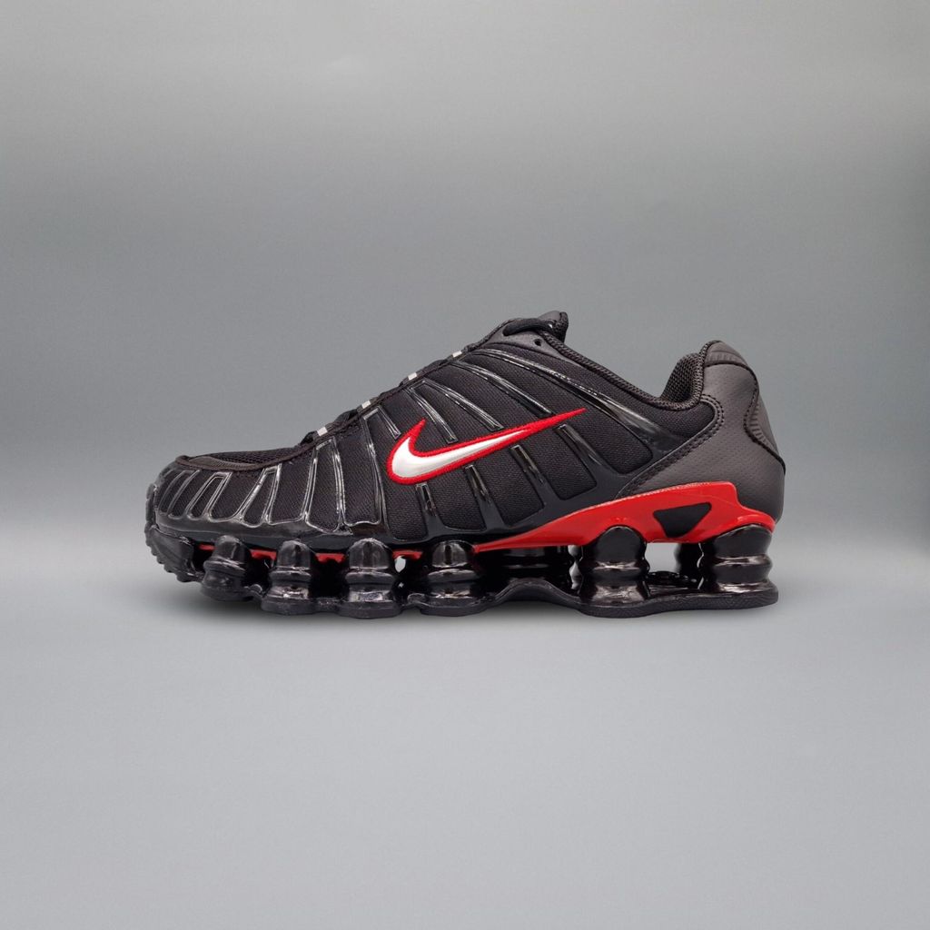 A side view of a Nike Shox TL sneaker against a plain gray background.