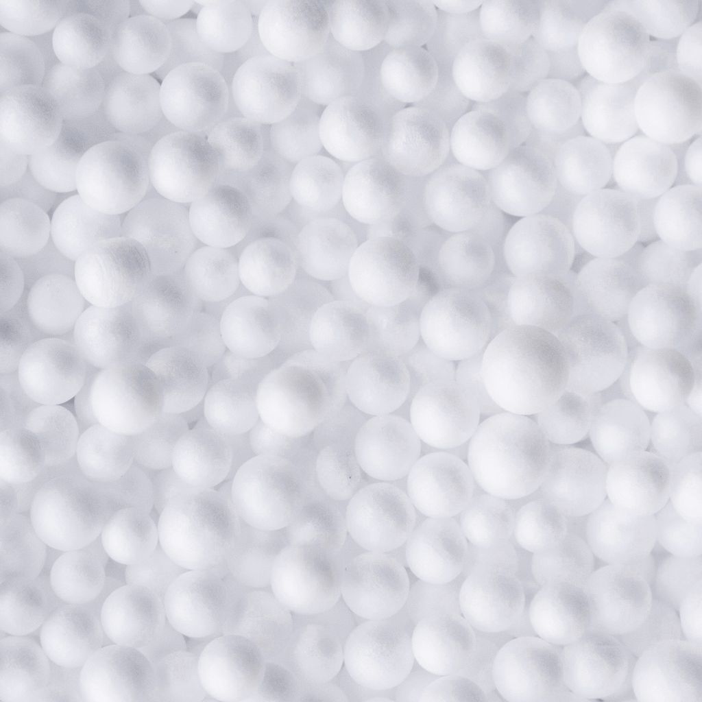 A close-up, top-down view of many small white EPS beads.