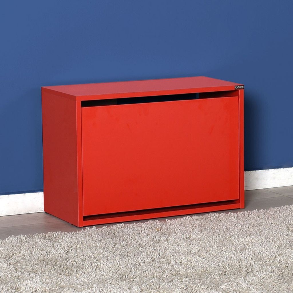 A red shoe cabinet against a blue wall and on a rug.