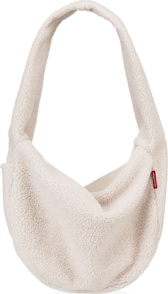 A cream-colored fuzzy sling bag is shown against a white background.
