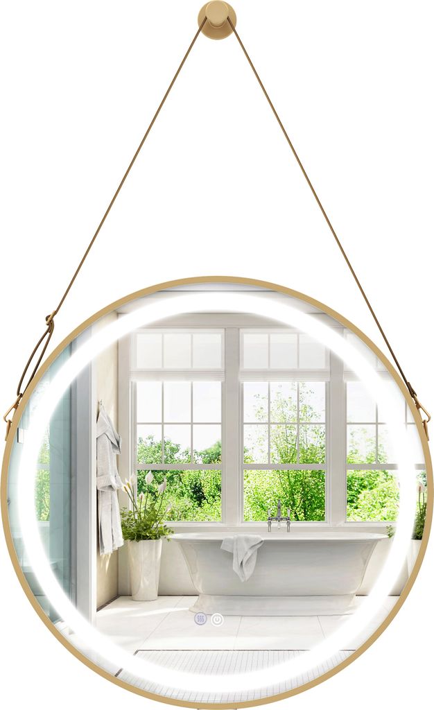 A round bathroom mirror with LED lighting, suspended by a strap, reflecting a bathroom interior with a bathtub and window.