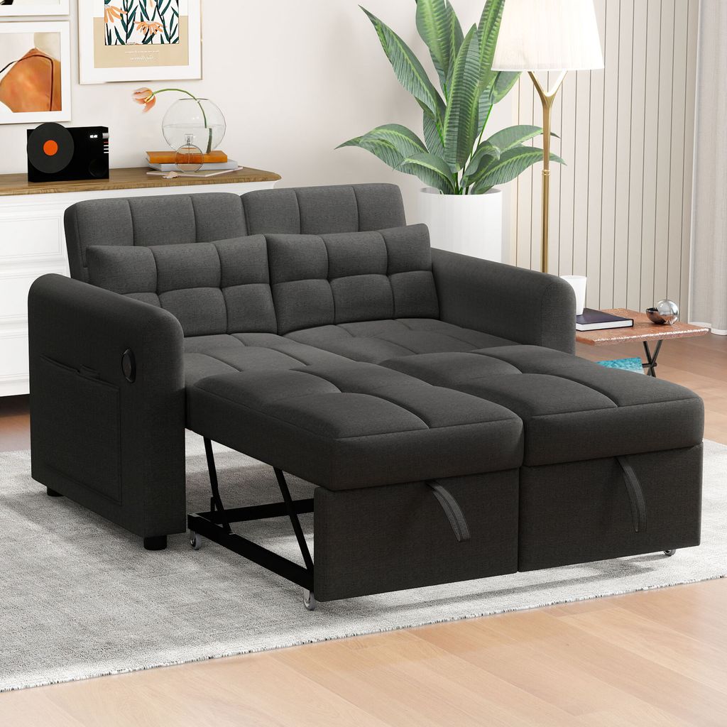 A gray sofa bed is shown in a living room setting.