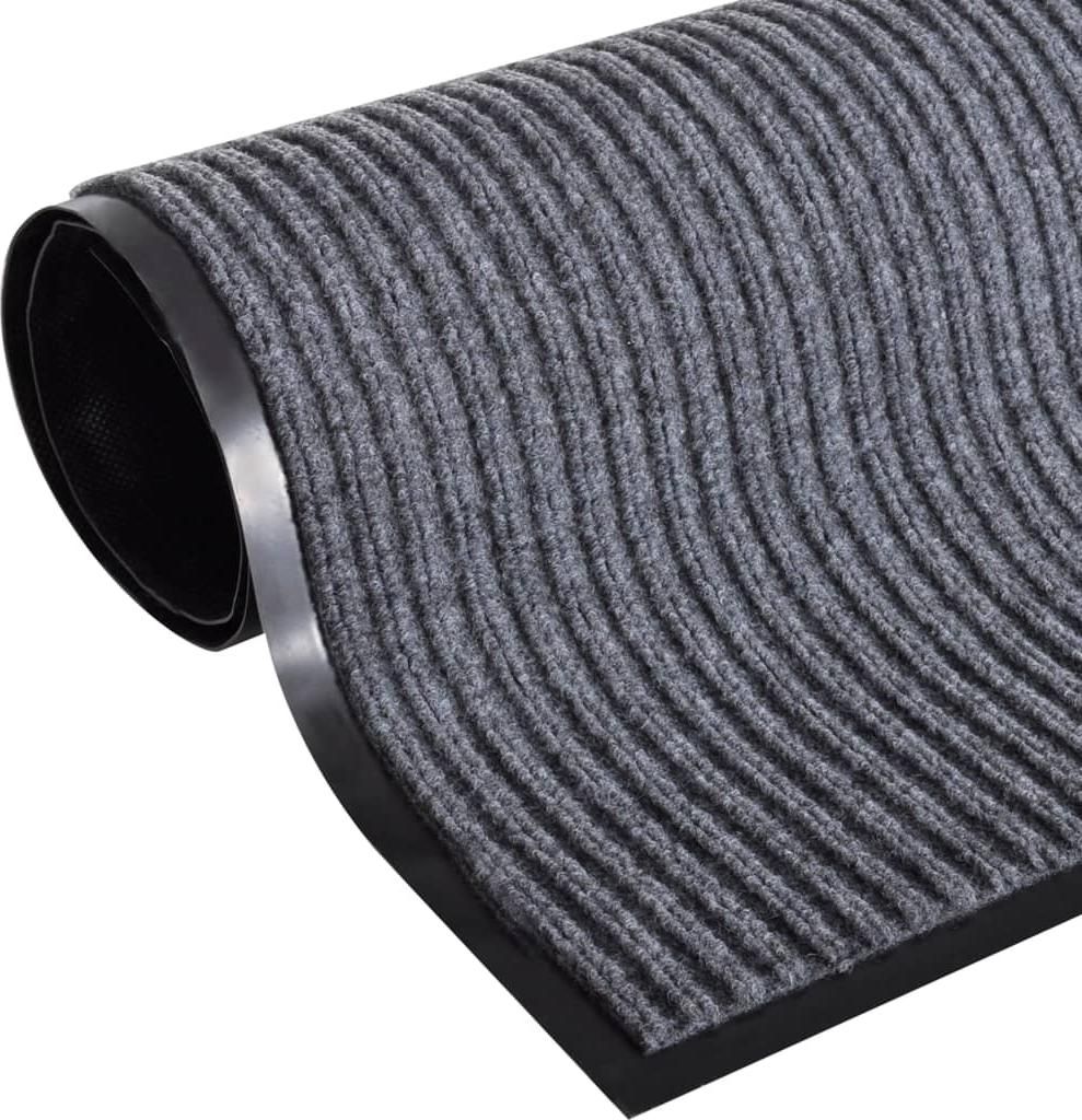 A close-up, rolled-up view of a grey ribbed doormat with a black rubber backing.