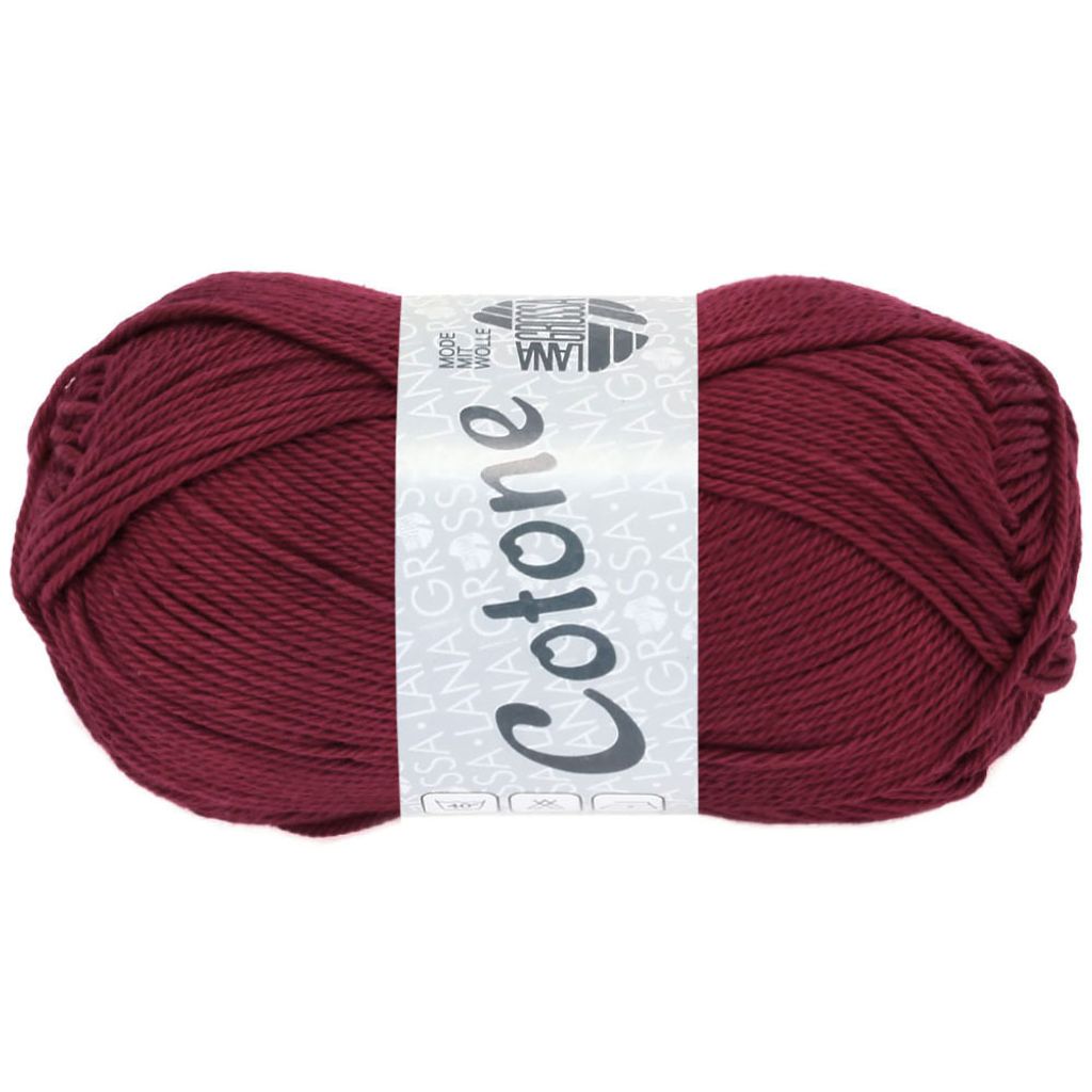 A ball of burgundy yarn with a label.