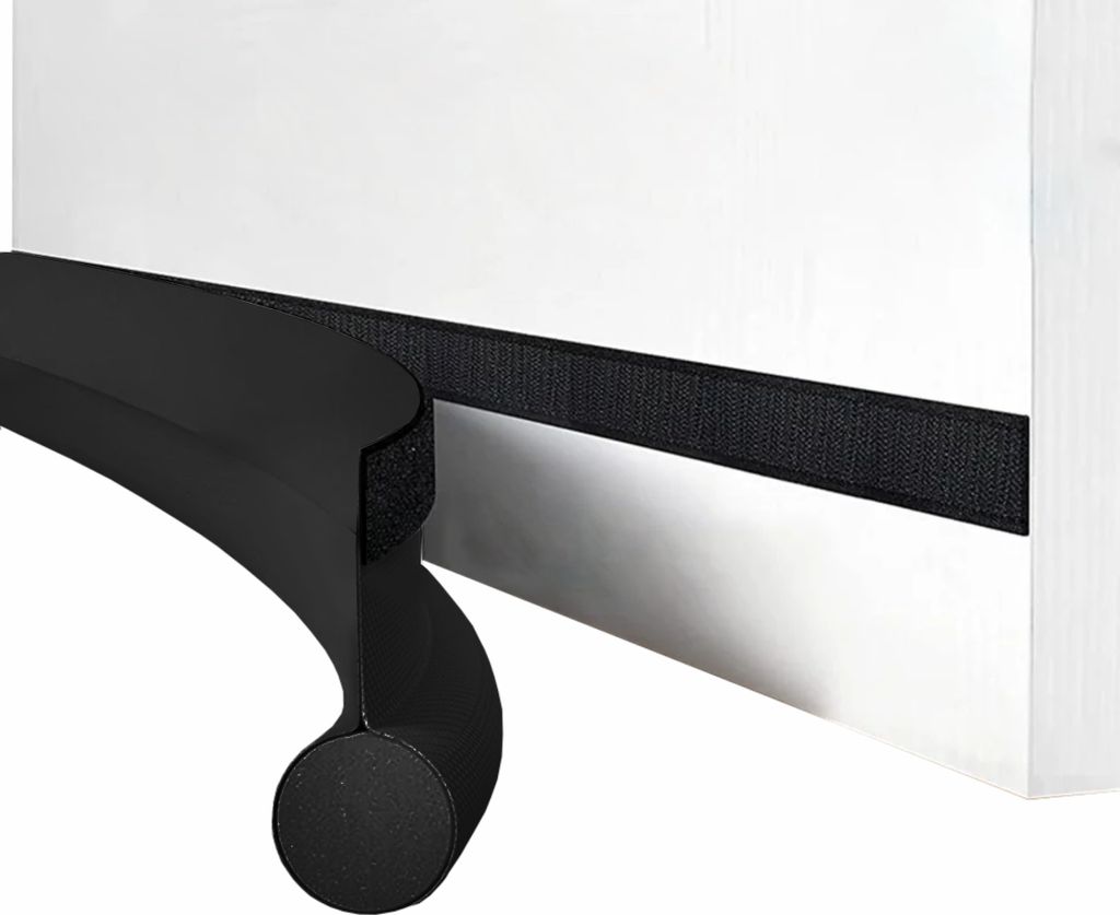 A close-up view of a black foam door seal with a velcro strip attached to a white surface.
