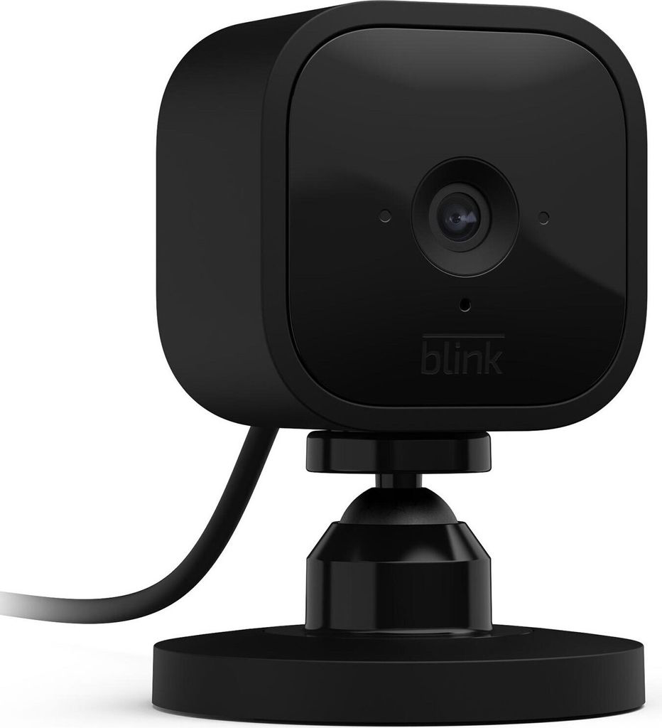 A black Blink Mini smart plug-in security camera is shown on a white background, mounted on a small black base with a cable extending to the left.
