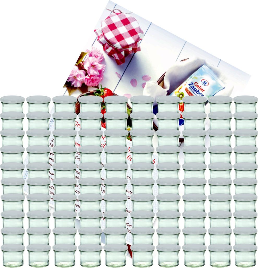 A collection of small glass jars with white lids, arranged in rows, with a decorative background featuring flowers, strawberries, and a recipe booklet.