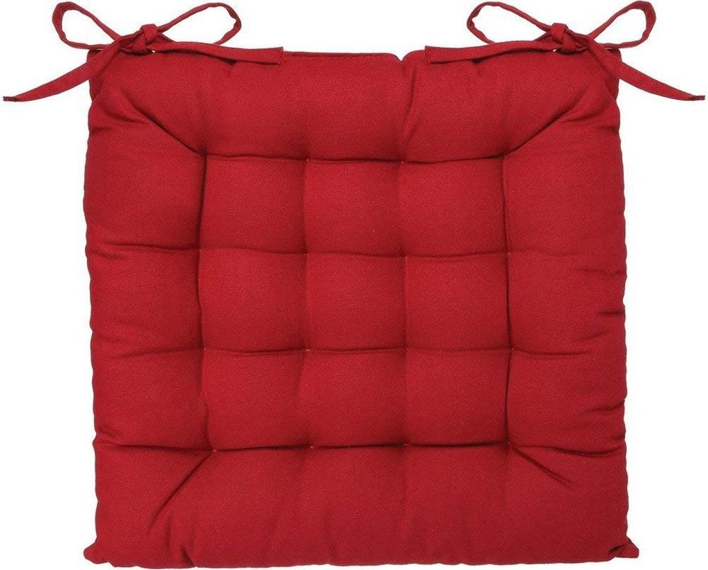 A red square seat cushion with ties on a white background.