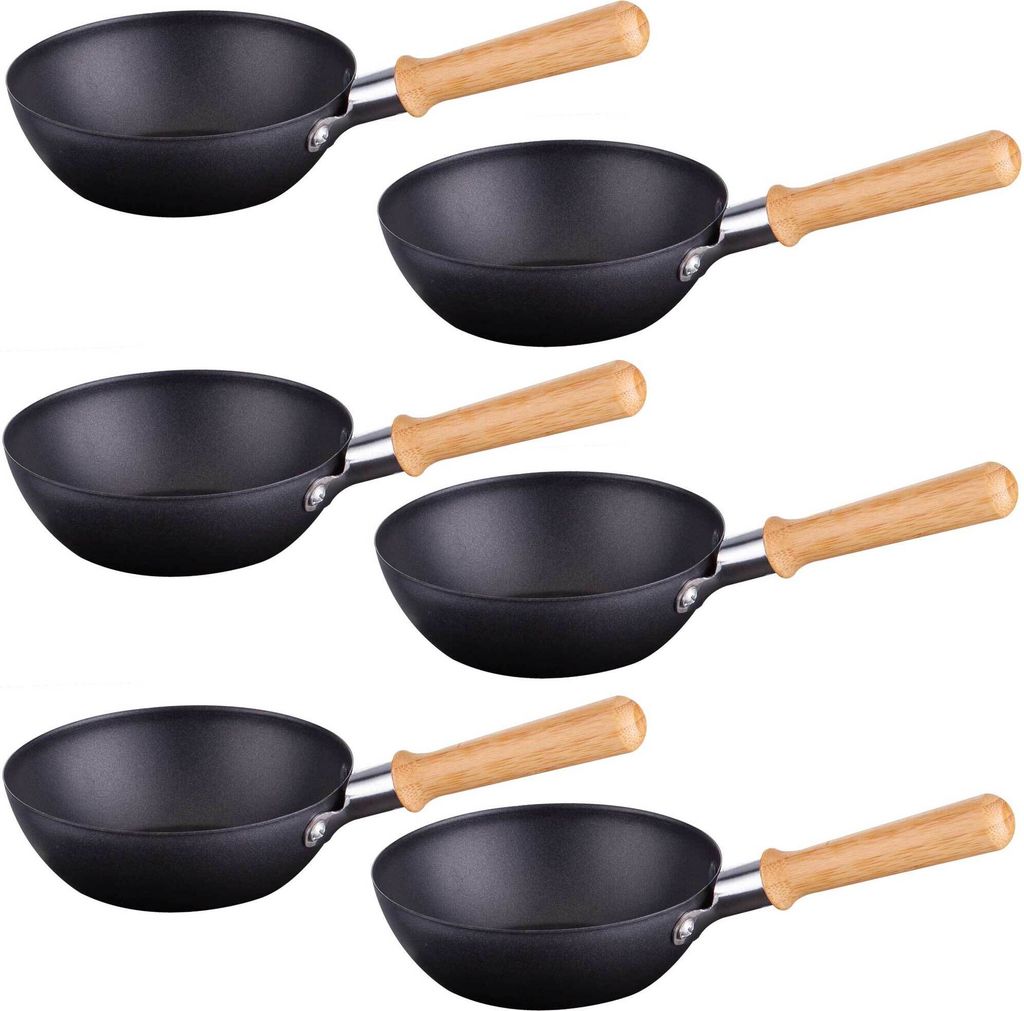 A collage of six individual black woks with light brown wooden handles.
