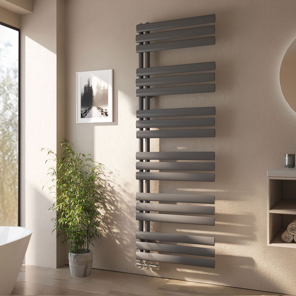 A modern bathroom with a radiator, plant, and artwork.