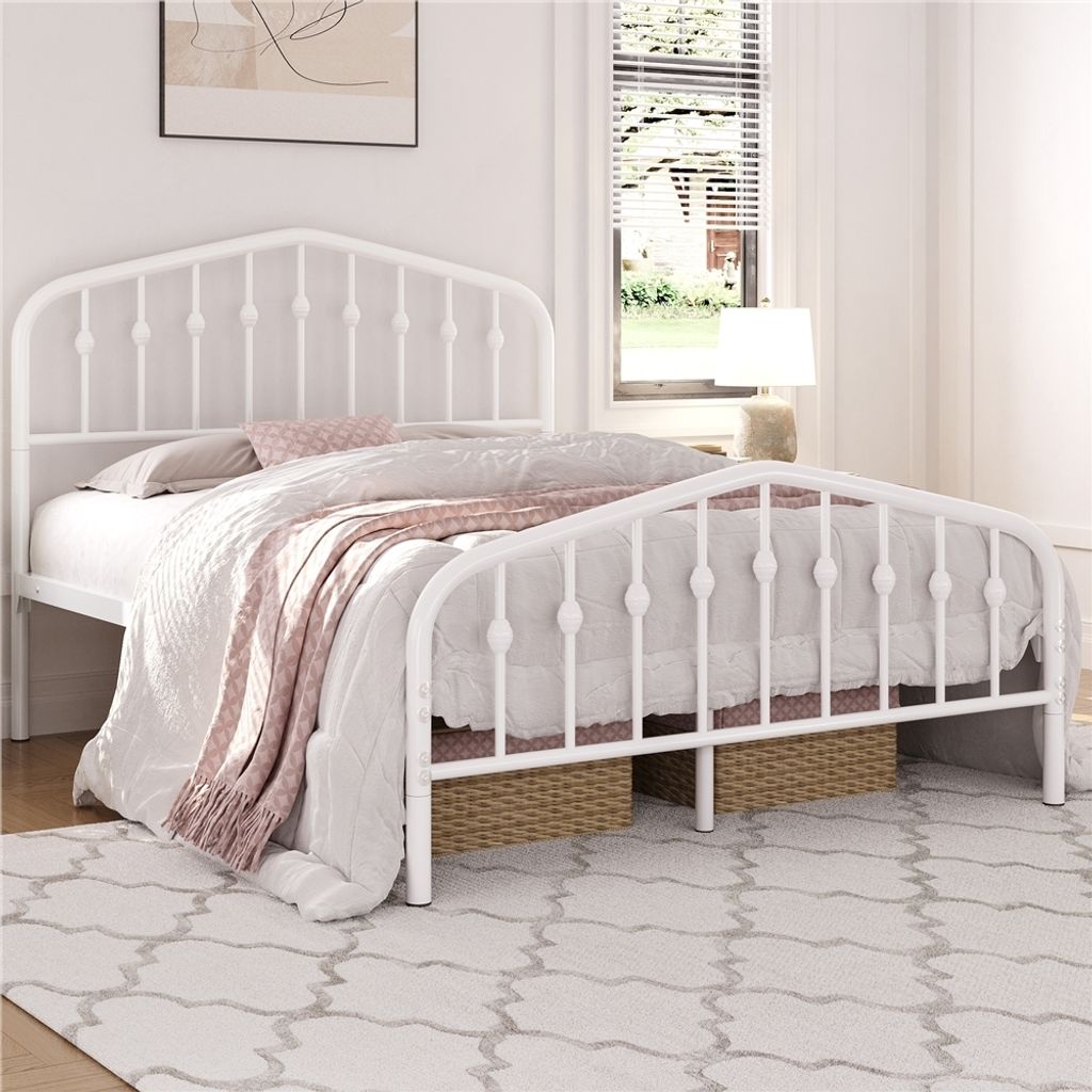 A white metal bed frame with bedding is shown in a bedroom.