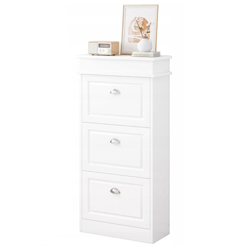 A white shoe cabinet with three drawers is shown against a white background. Decorative items are placed on top of the cabinet.