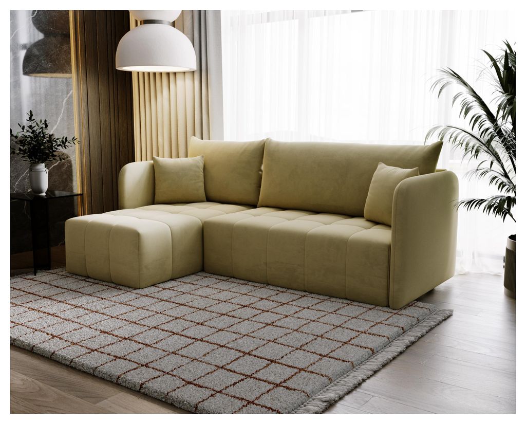 A sectional sofa is shown in a living room setting, placed on a rug in front of a window with sheer curtains.