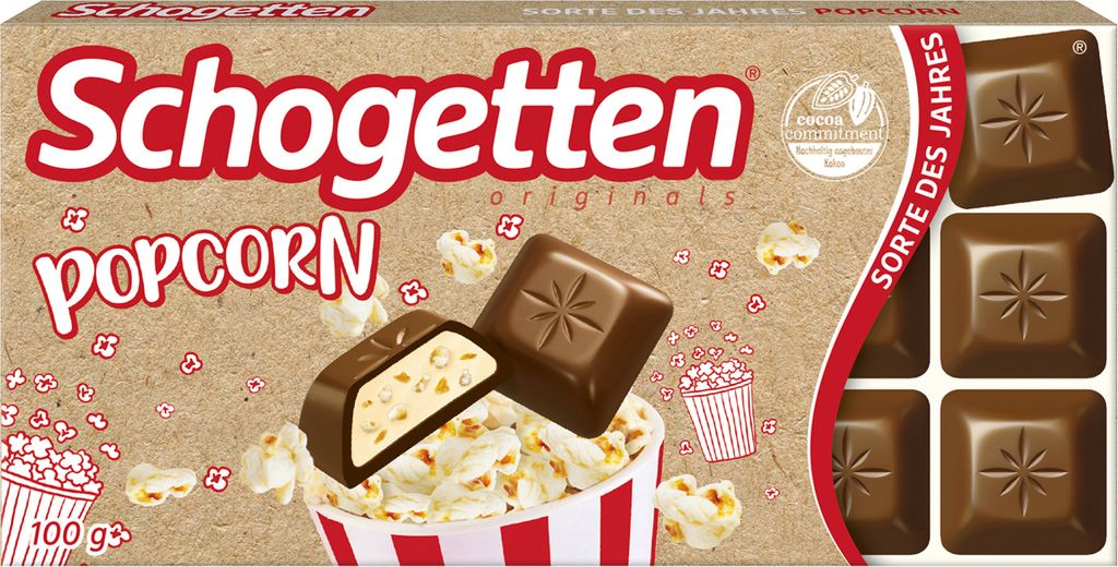 A box of Schogetten Popcorn chocolate bars with popcorn scattered around.