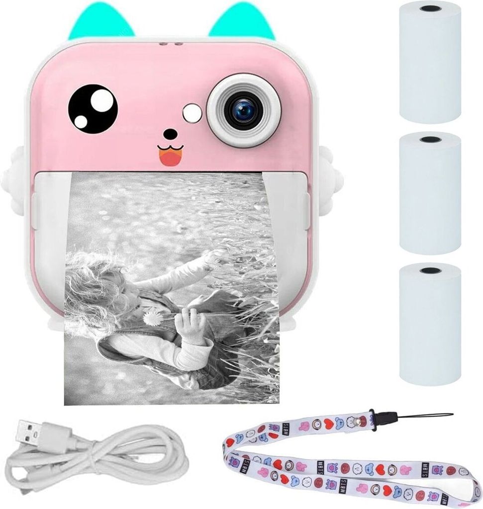 A pink mini instant camera with a cute cat design, printing a black and white photo of a child. Accessories like USB cable, lanyard, and paper rolls are also shown.